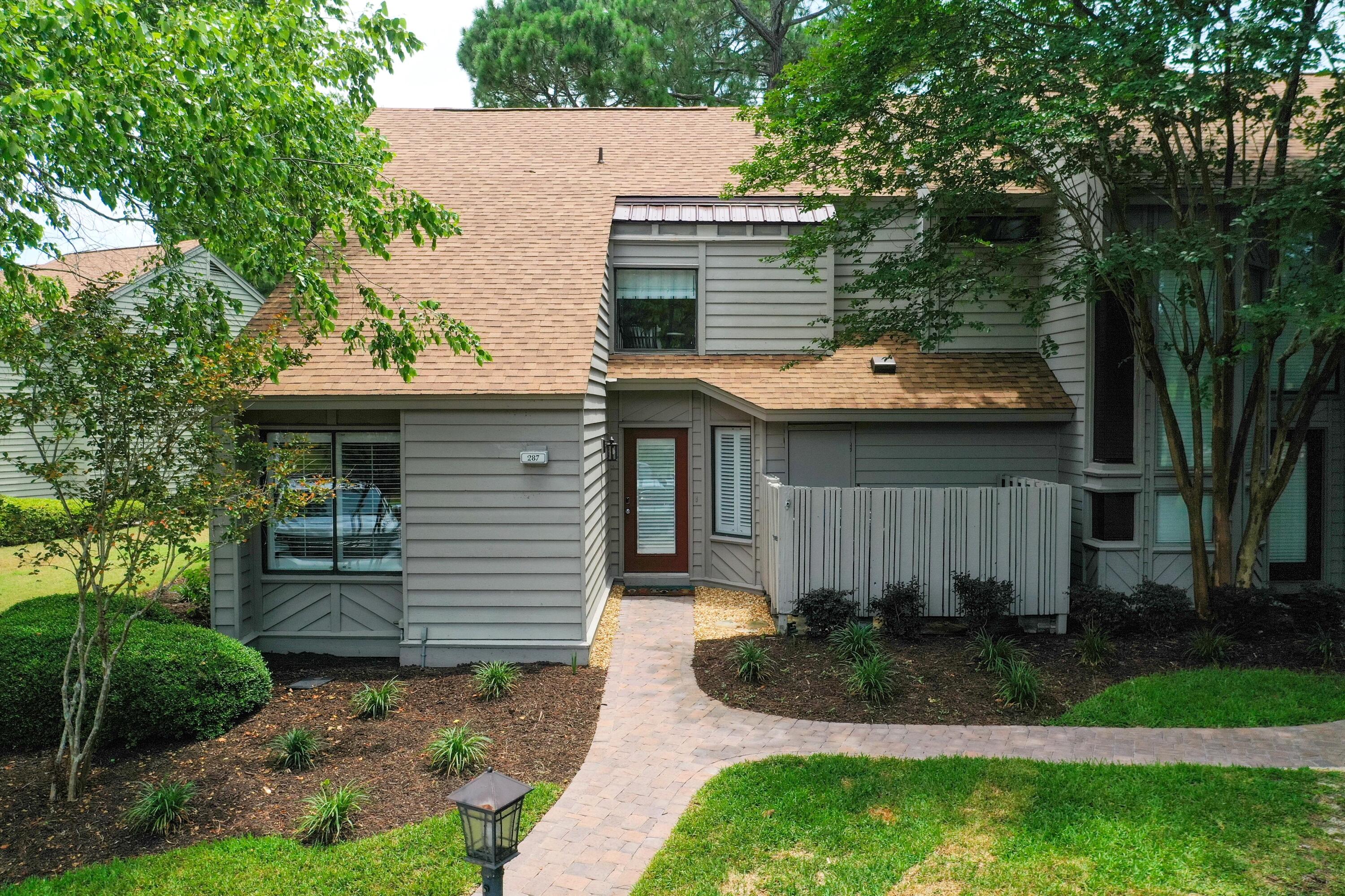 a front view of a house with a garden