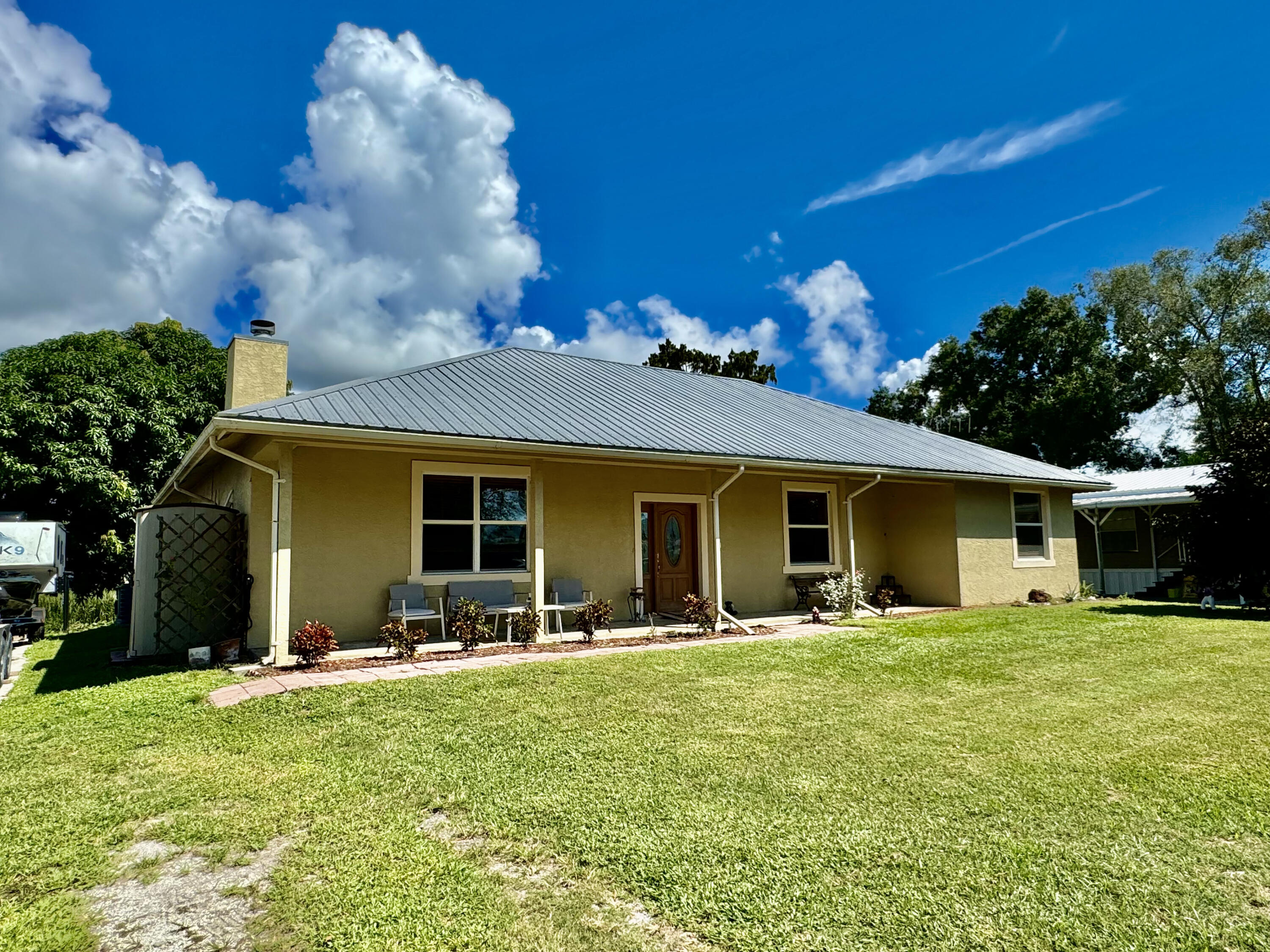 a front view of house with yard and green space