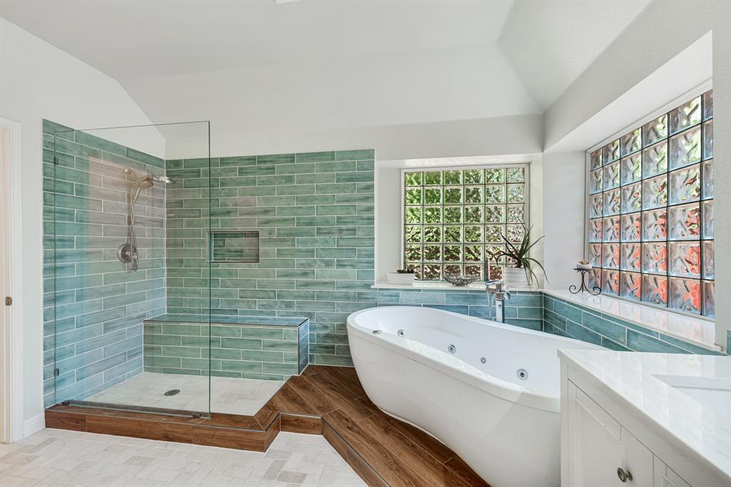 a bathroom with a bathtub and a shower