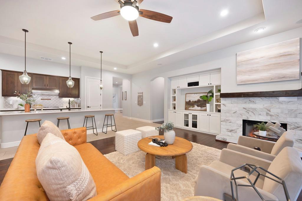 a living room with fireplace kitchen and a dining table