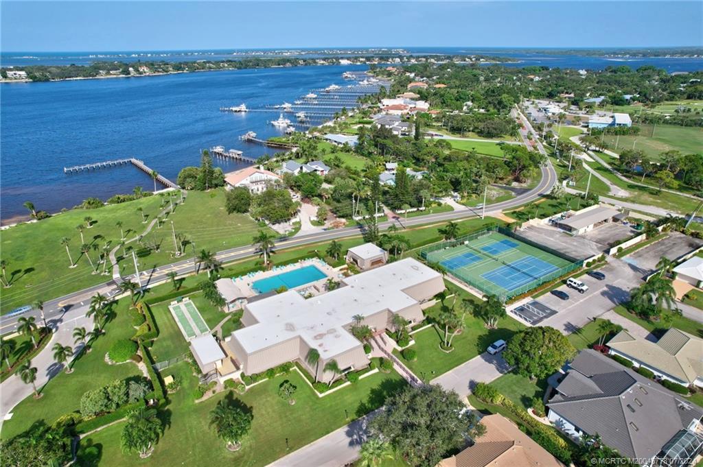 an aerial view of residential houses with outdoor space and river