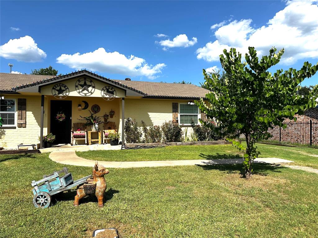 a view of a house with a yard and porch