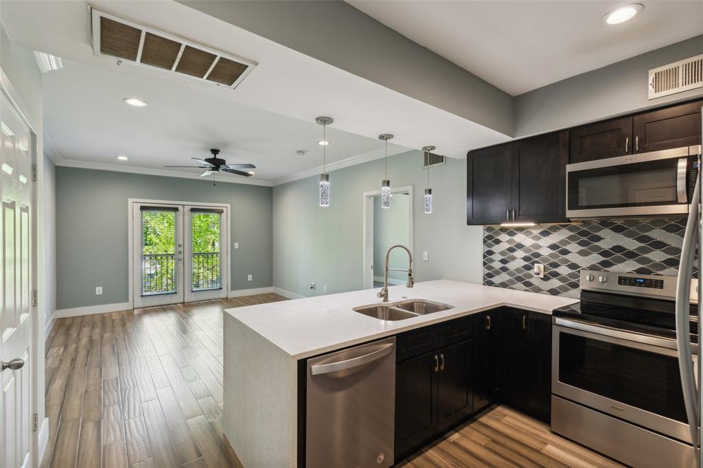 a kitchen with a sink and a stove top oven