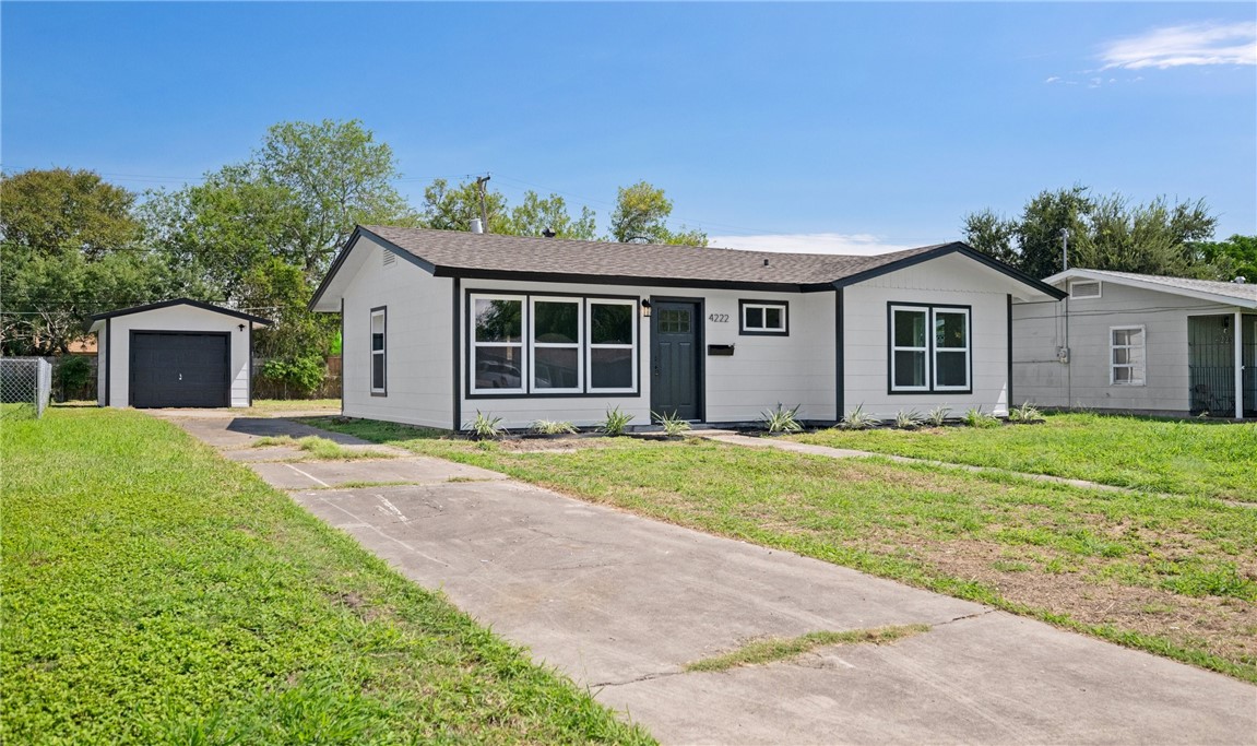 a view of an house with backyard space and garden