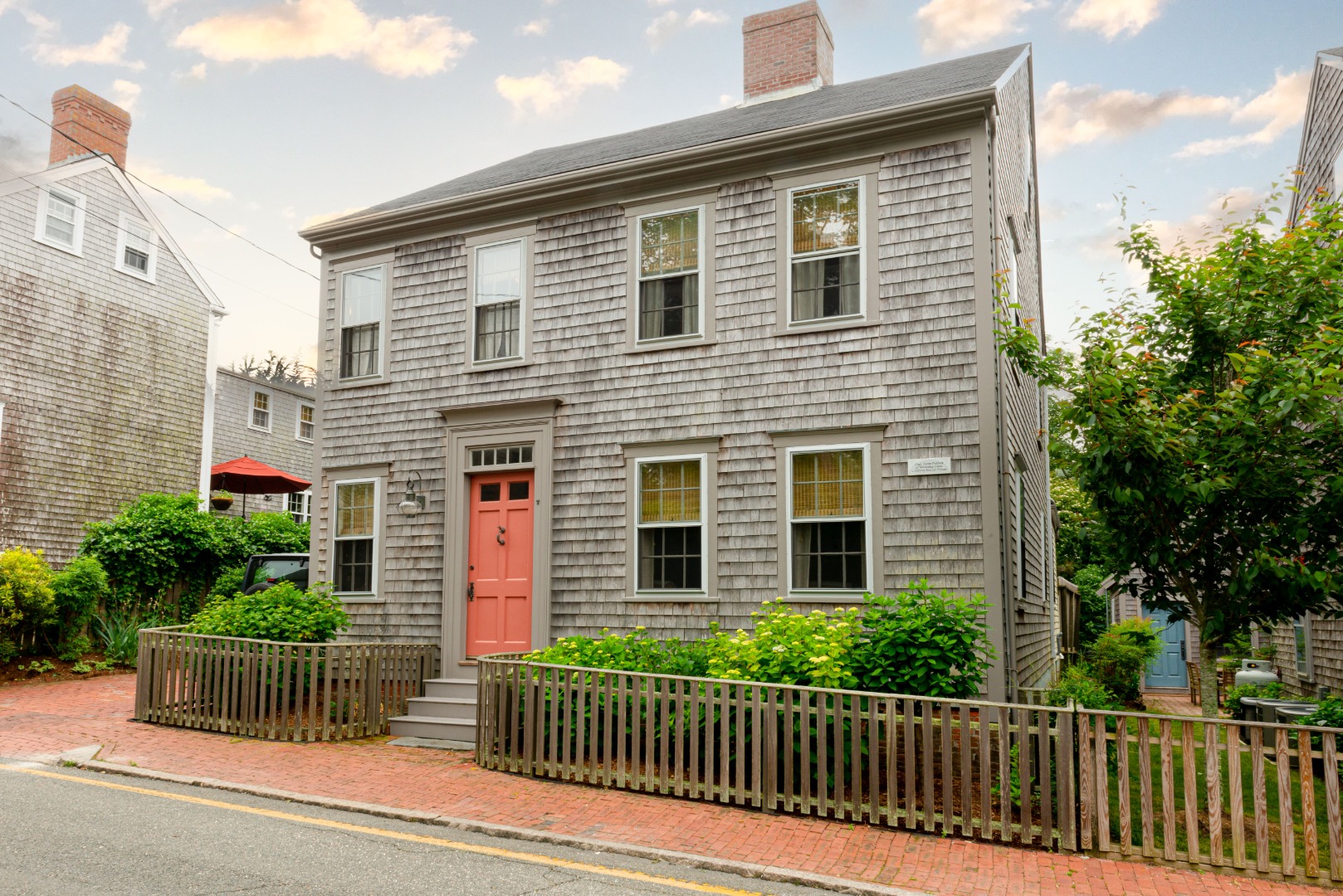 a front view of a house with a fence