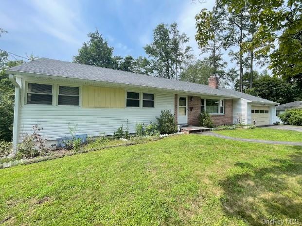 Ranch-style home with a garage and a front yard