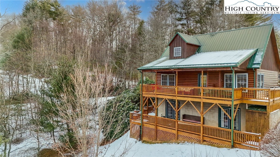 a view of a house with wooden fence