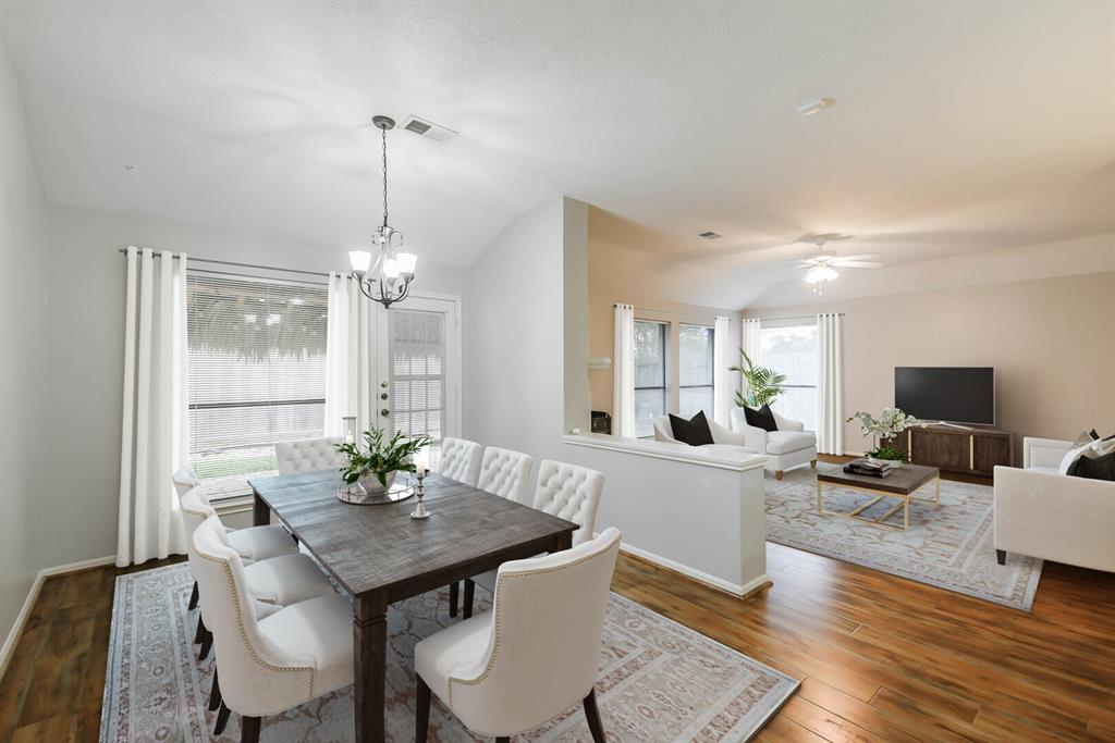 a view of a dining room with furniture window and wooden floor