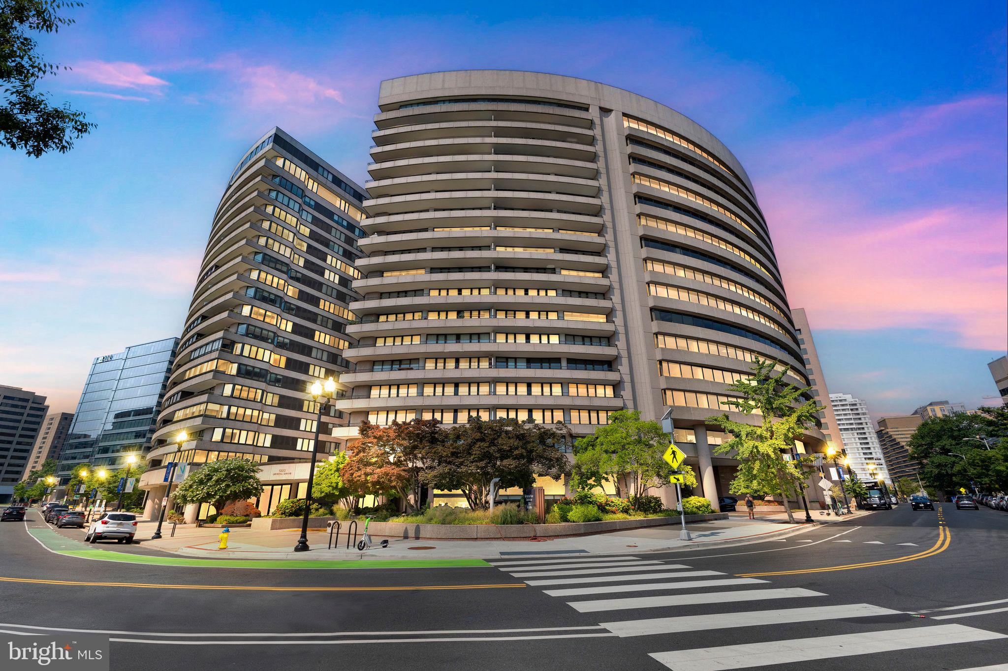 a view of a tall building next to a road