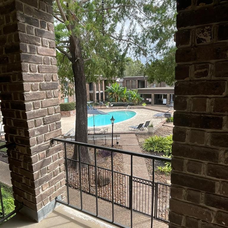 a view of a balcony with yard