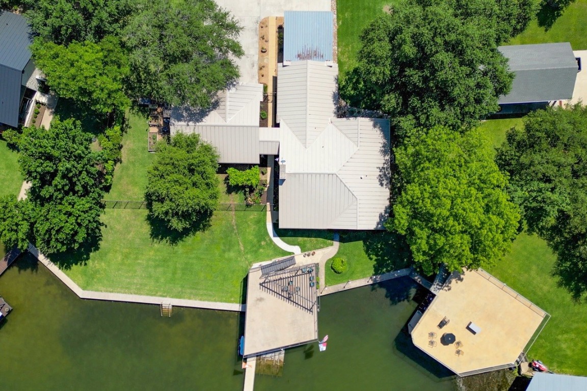 an aerial view of a house with a garden and trees