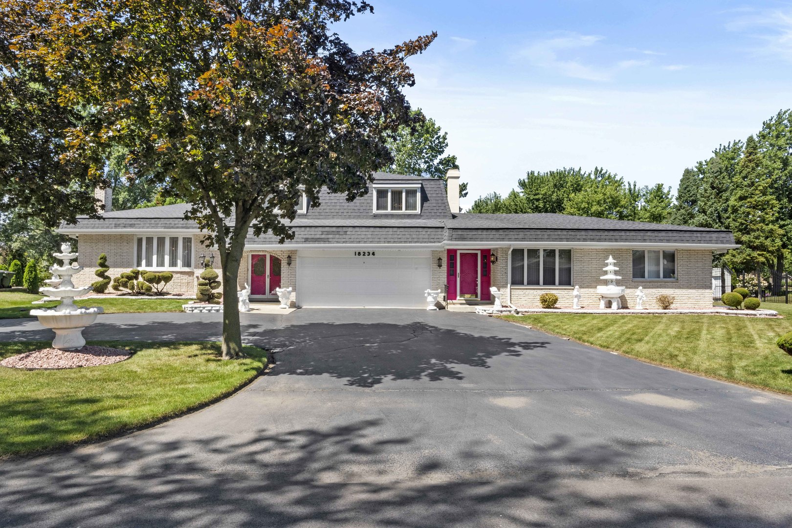 a front view of house with yard and green space