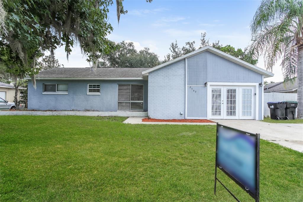 a front view of house with yard and green space