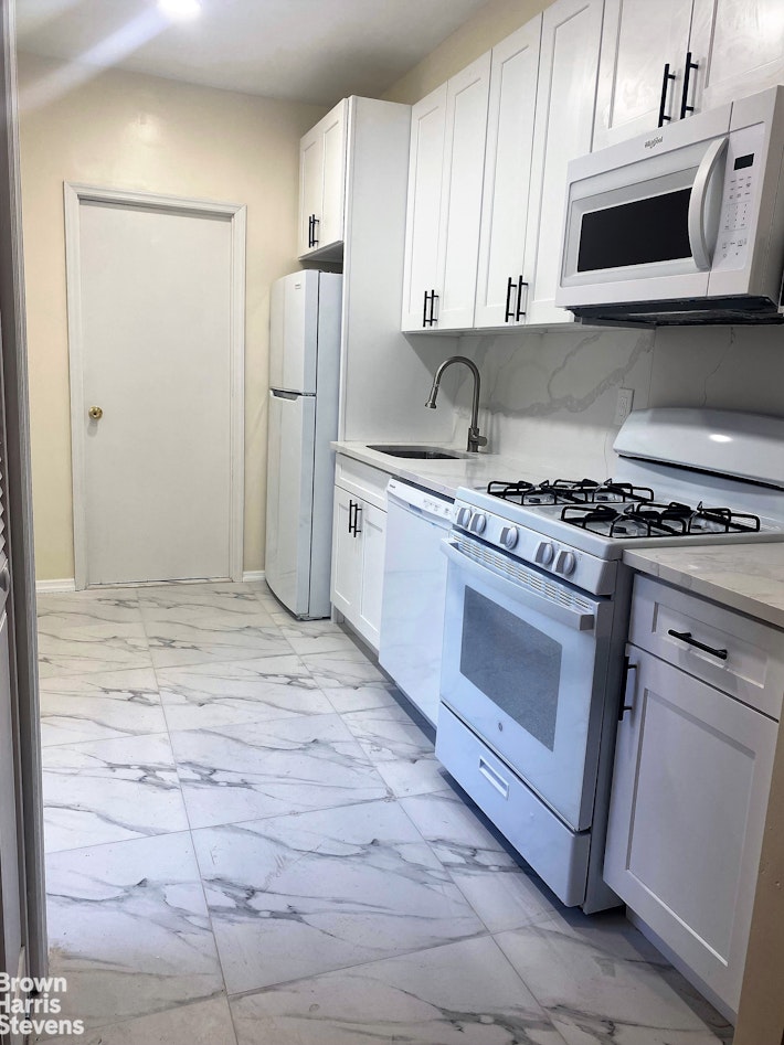 a kitchen with a stove and a refrigerator