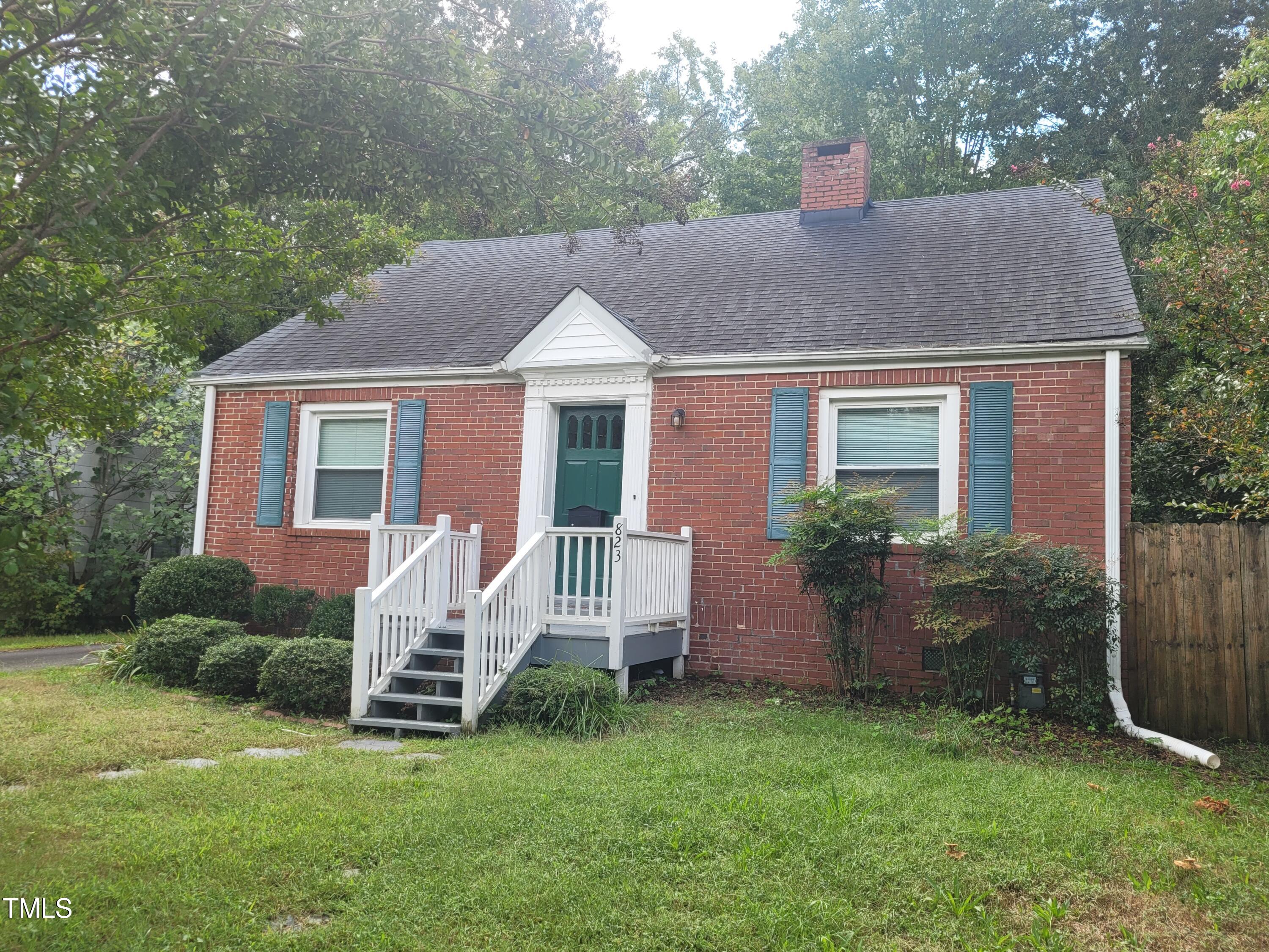 a front view of a house with a yard and porch