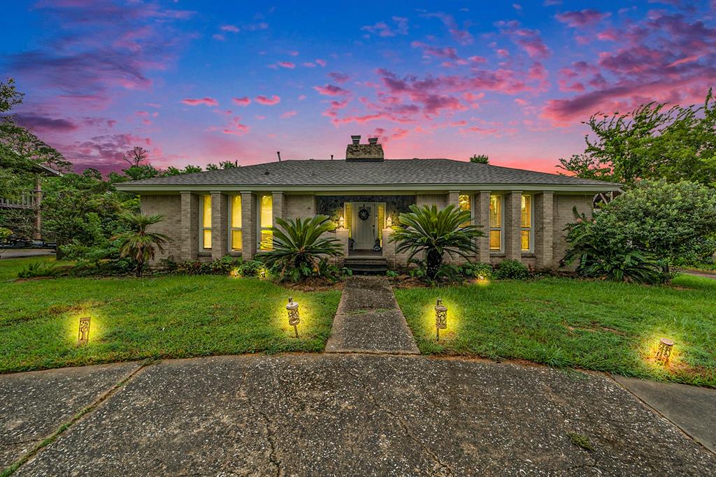 a view of a house with swimming pool yard and a patio