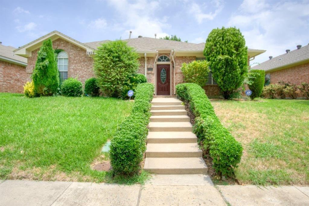 a view of a house with a yard and plants