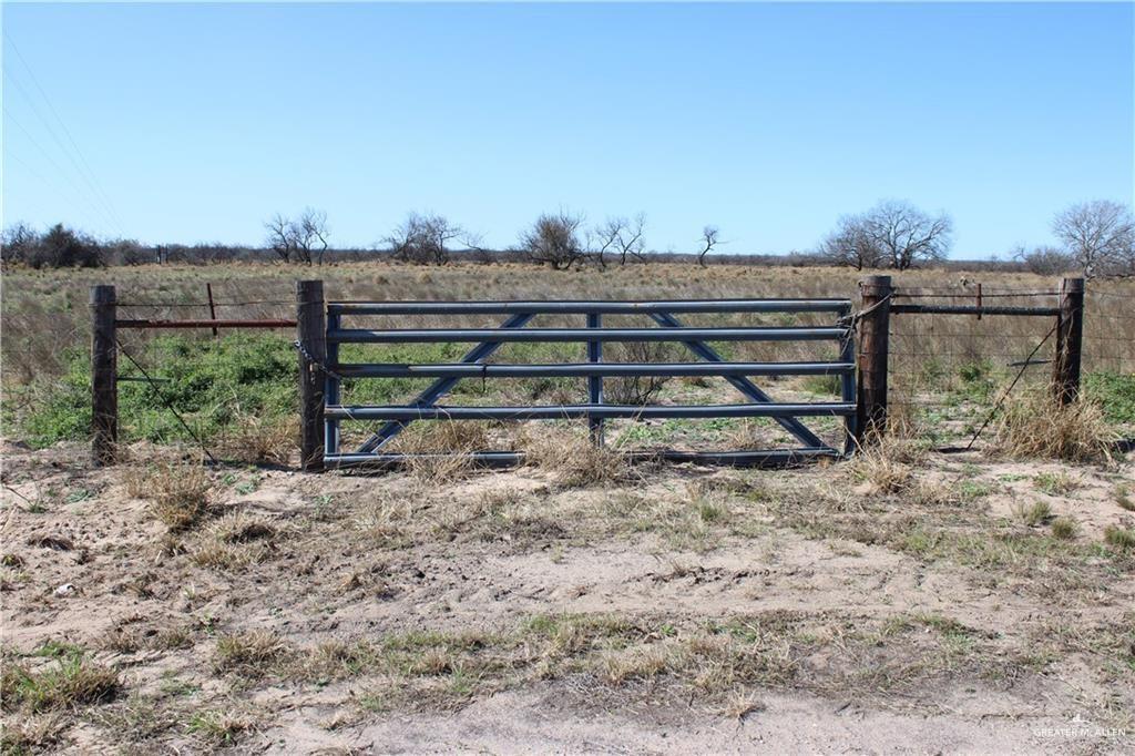 a view of a yard with wooden fence