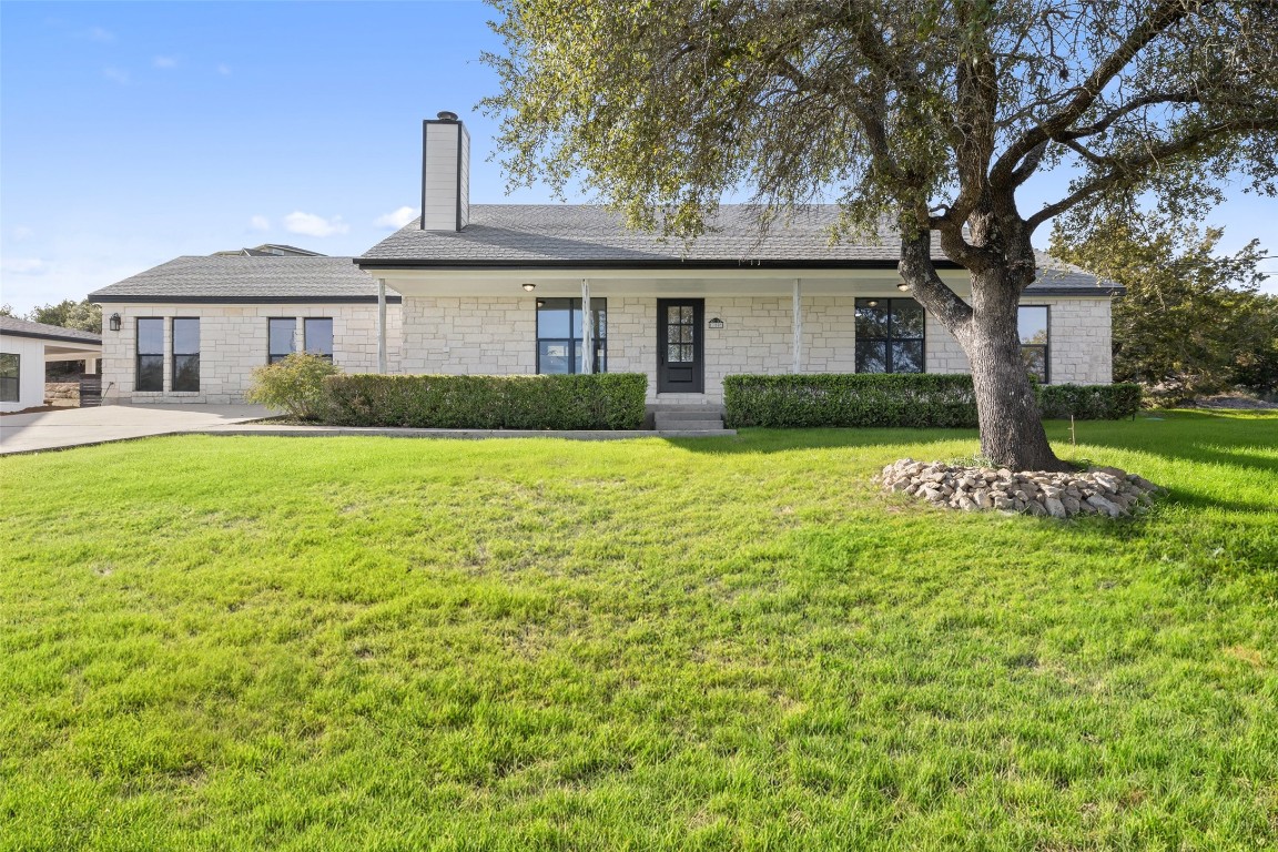 a front view of a house with yard and green space