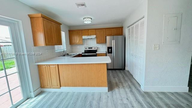 a kitchen with stainless steel appliances a refrigerator and a stove