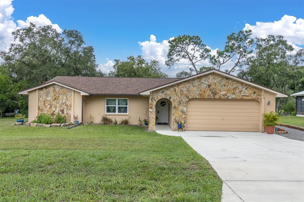 a front view of a house with a yard and garage