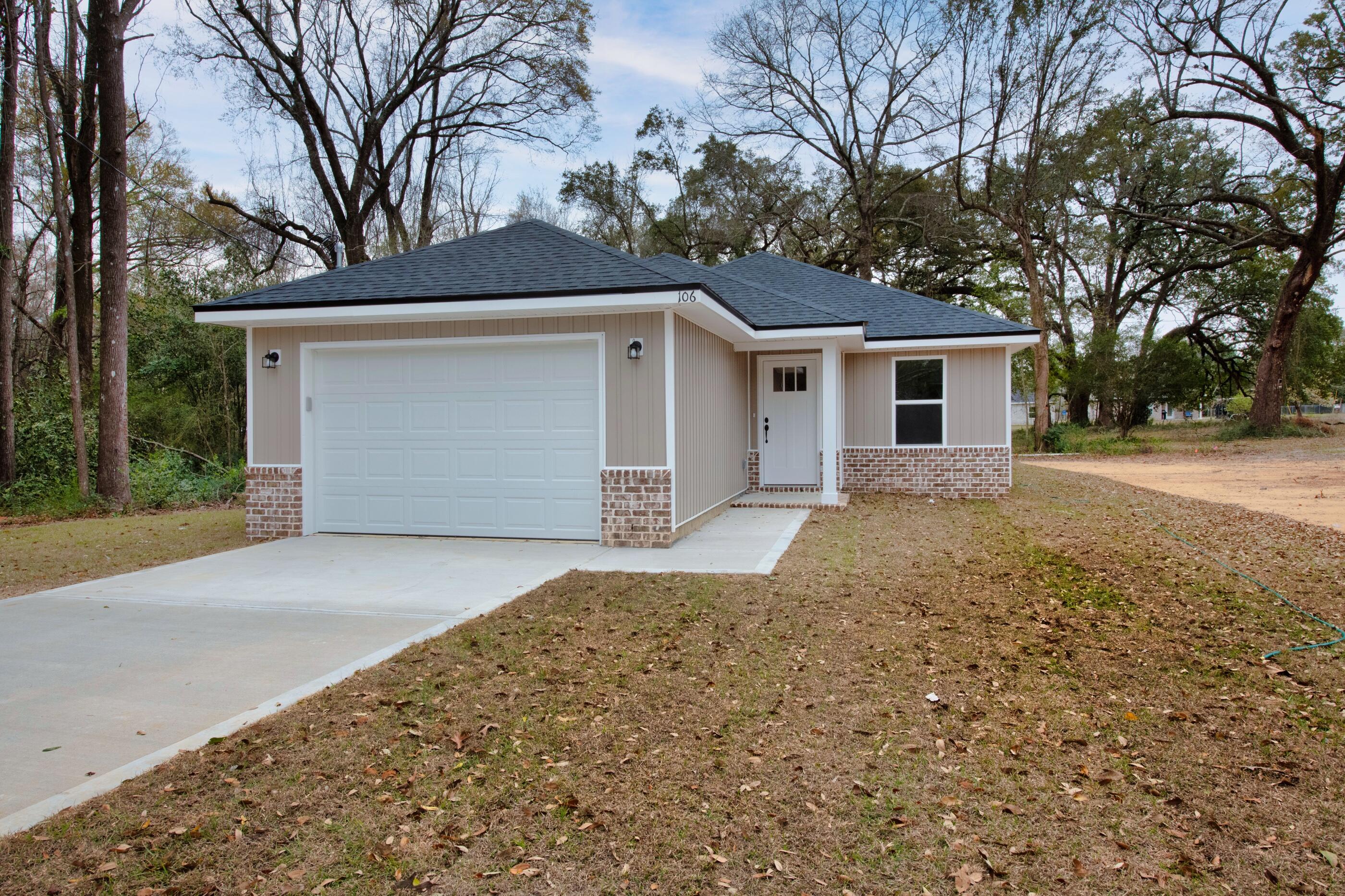 a front view of house with yard and trees