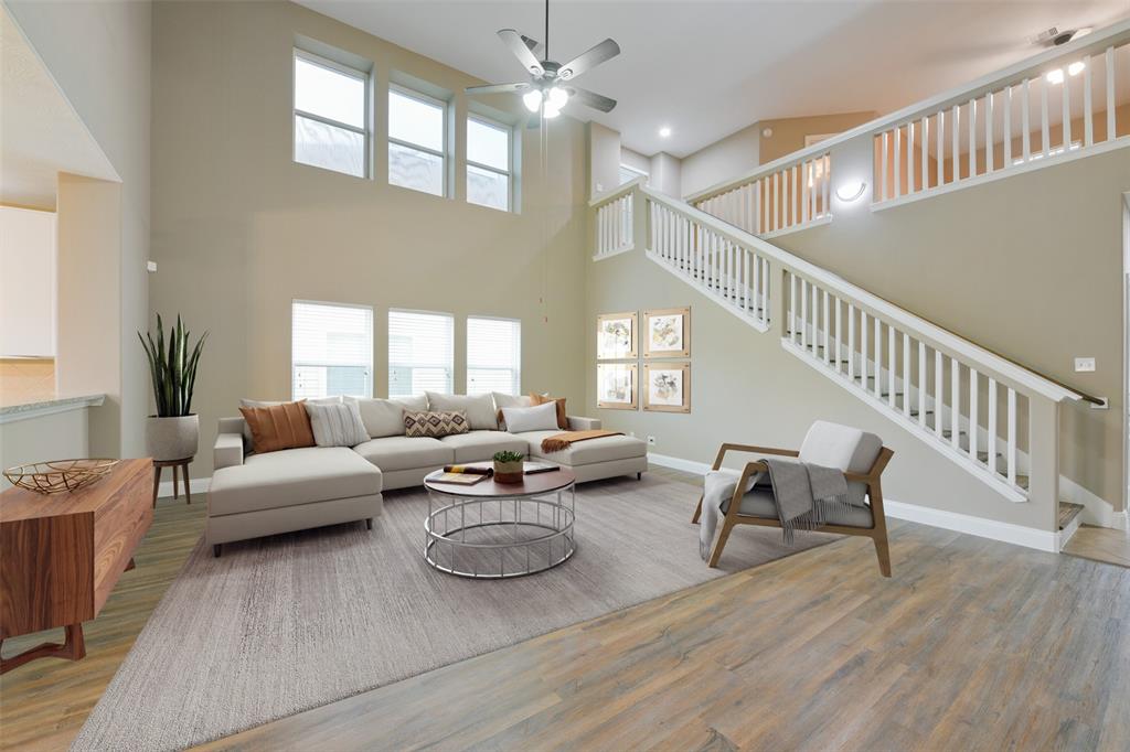 a living room with furniture and a chandelier