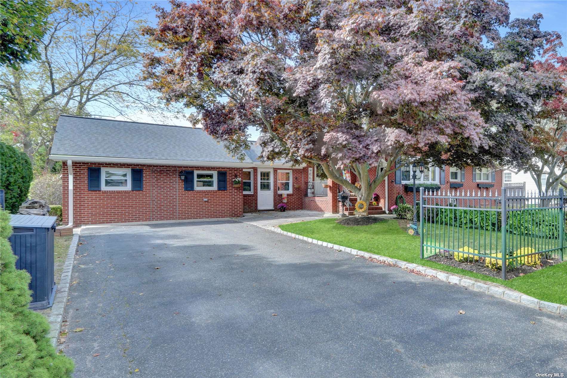 a view of a house with a big yard and large trees