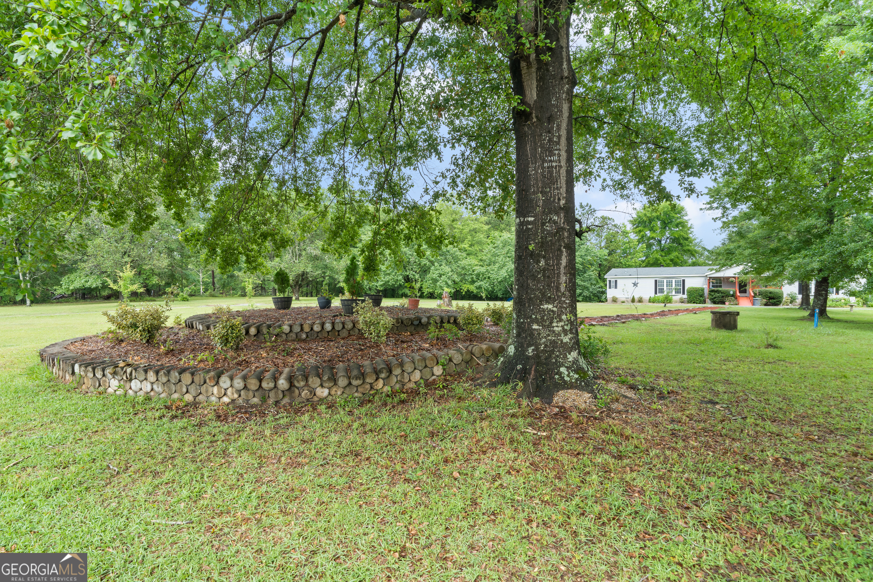 a big yard with lots of green space and trees