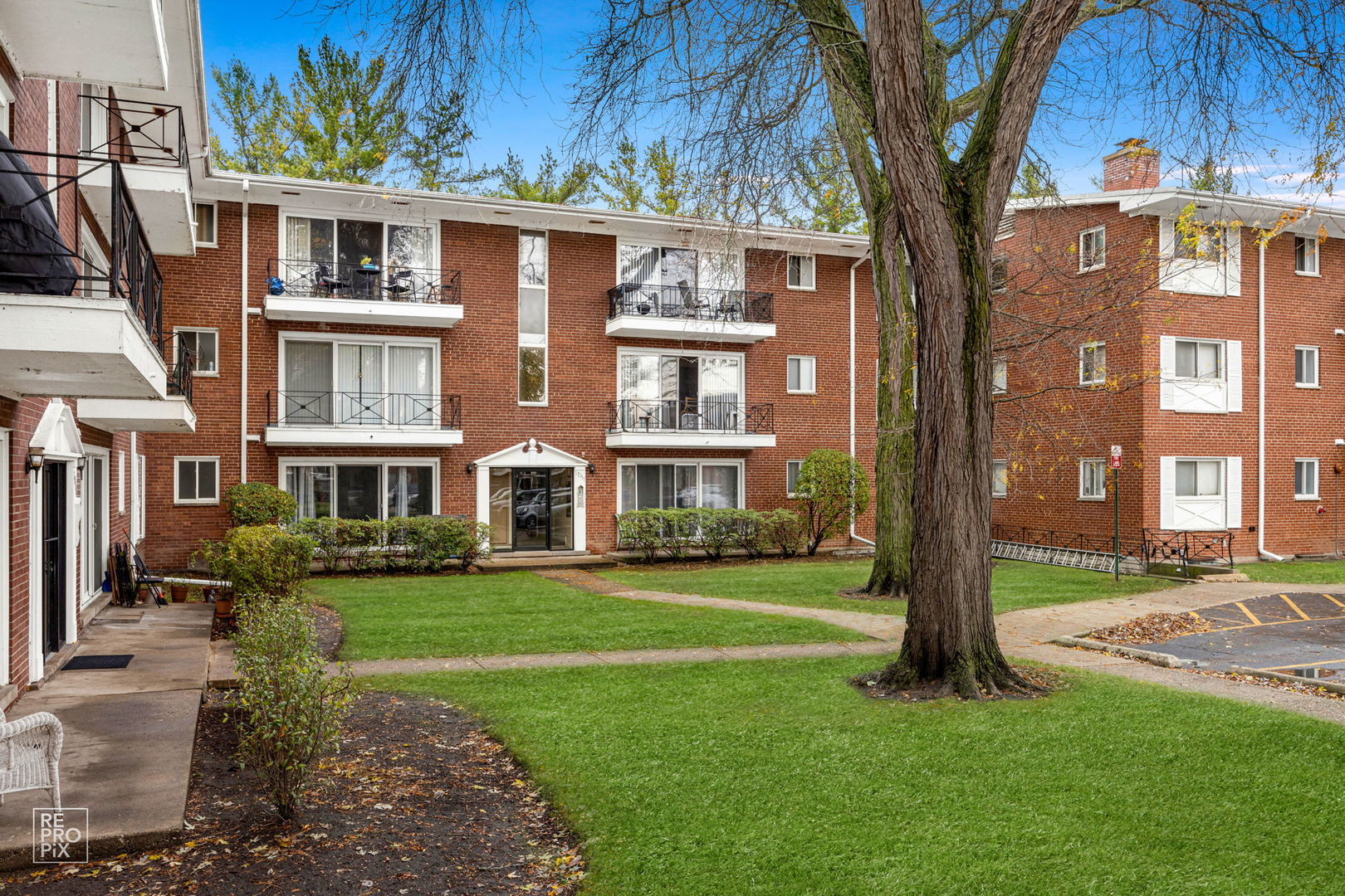 a front view of a residential apartment building with a yard