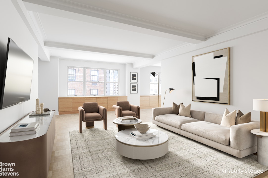 a living room with furniture a large window and a flat screen tv