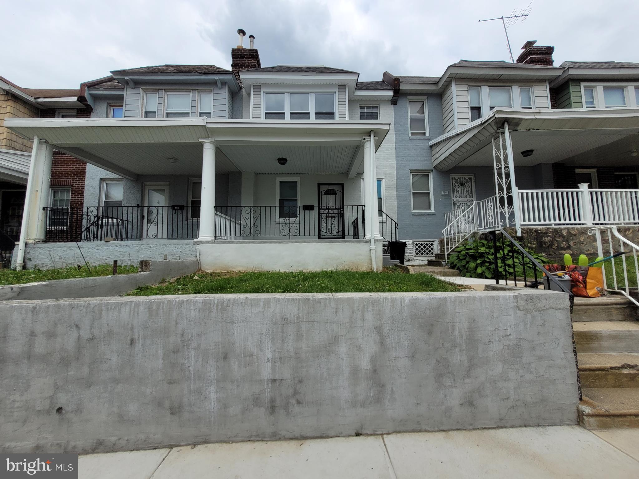 front view of a building with a garden