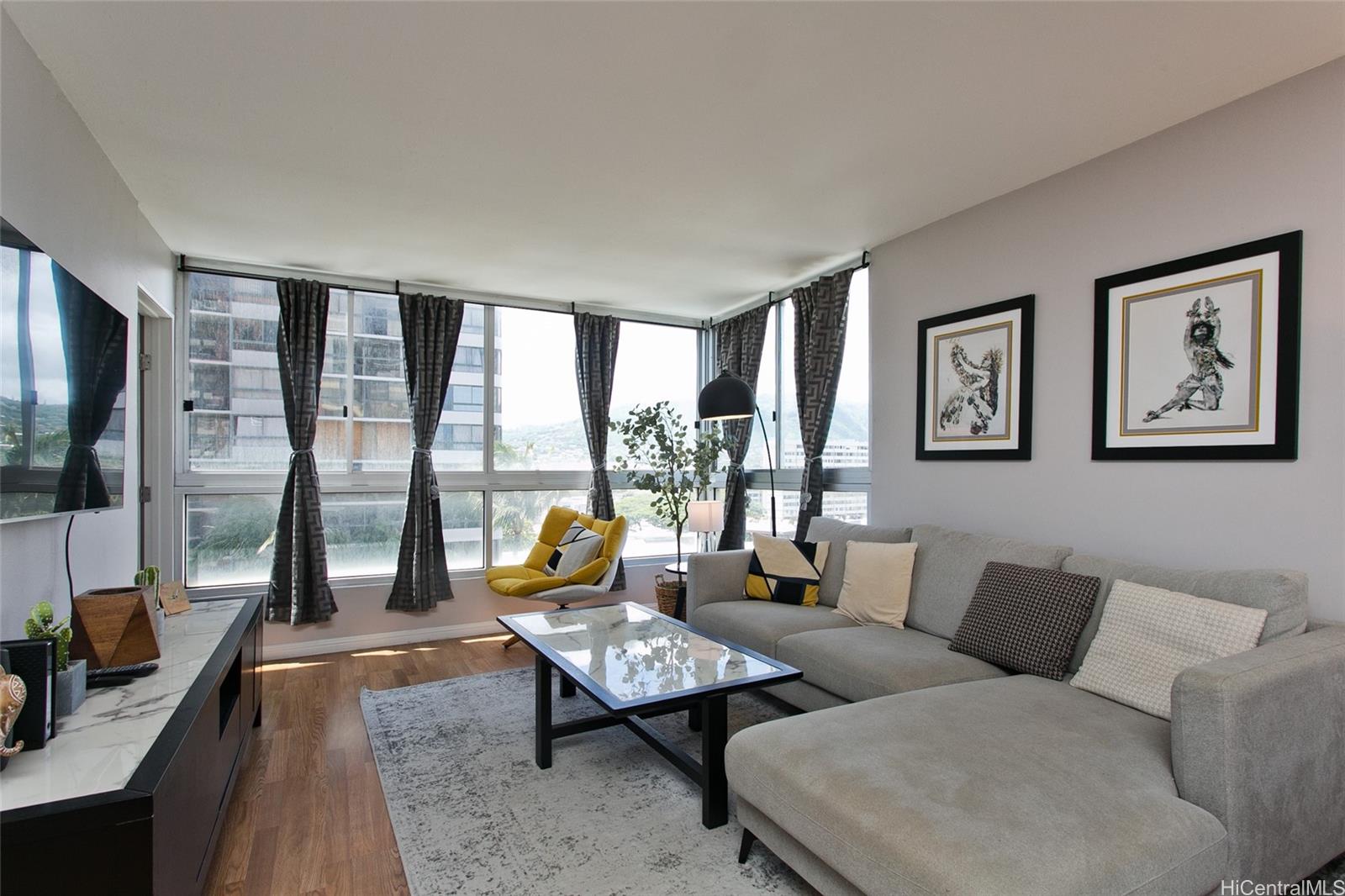 a living room with furniture and a floor to ceiling window