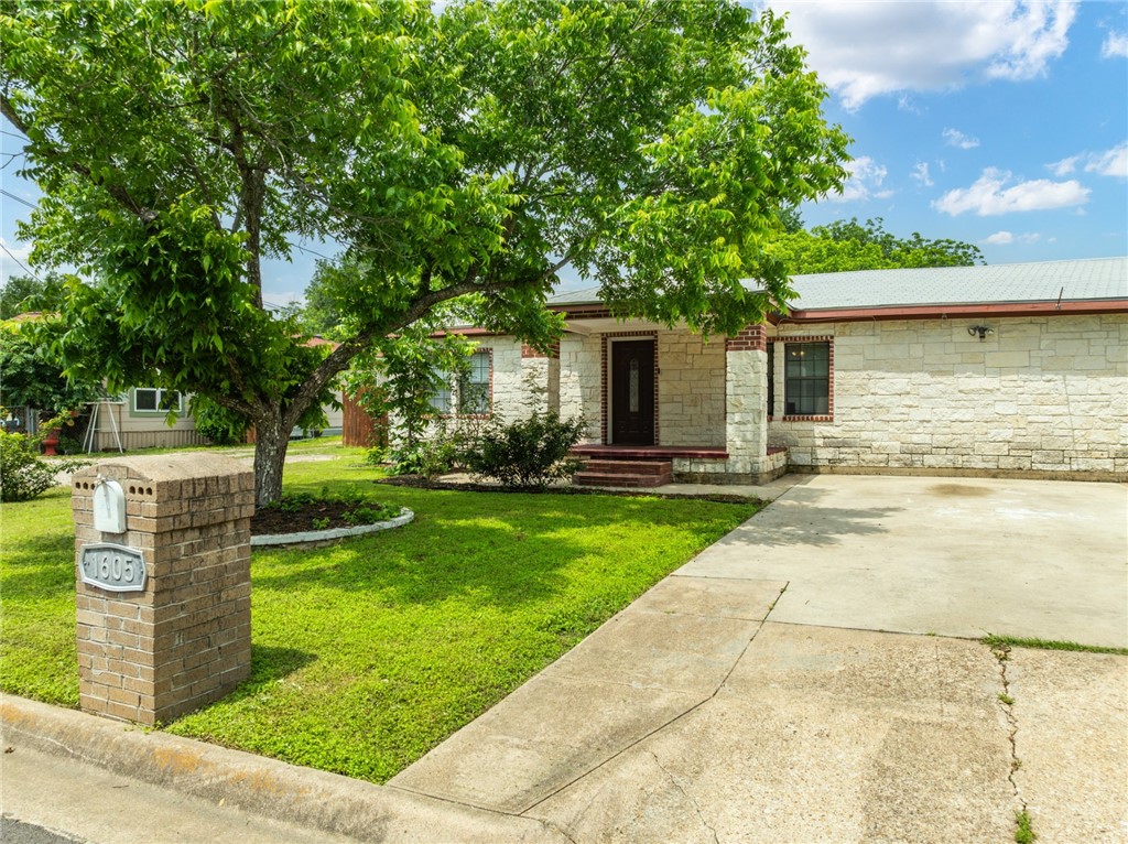 a front view of house with yard and green space