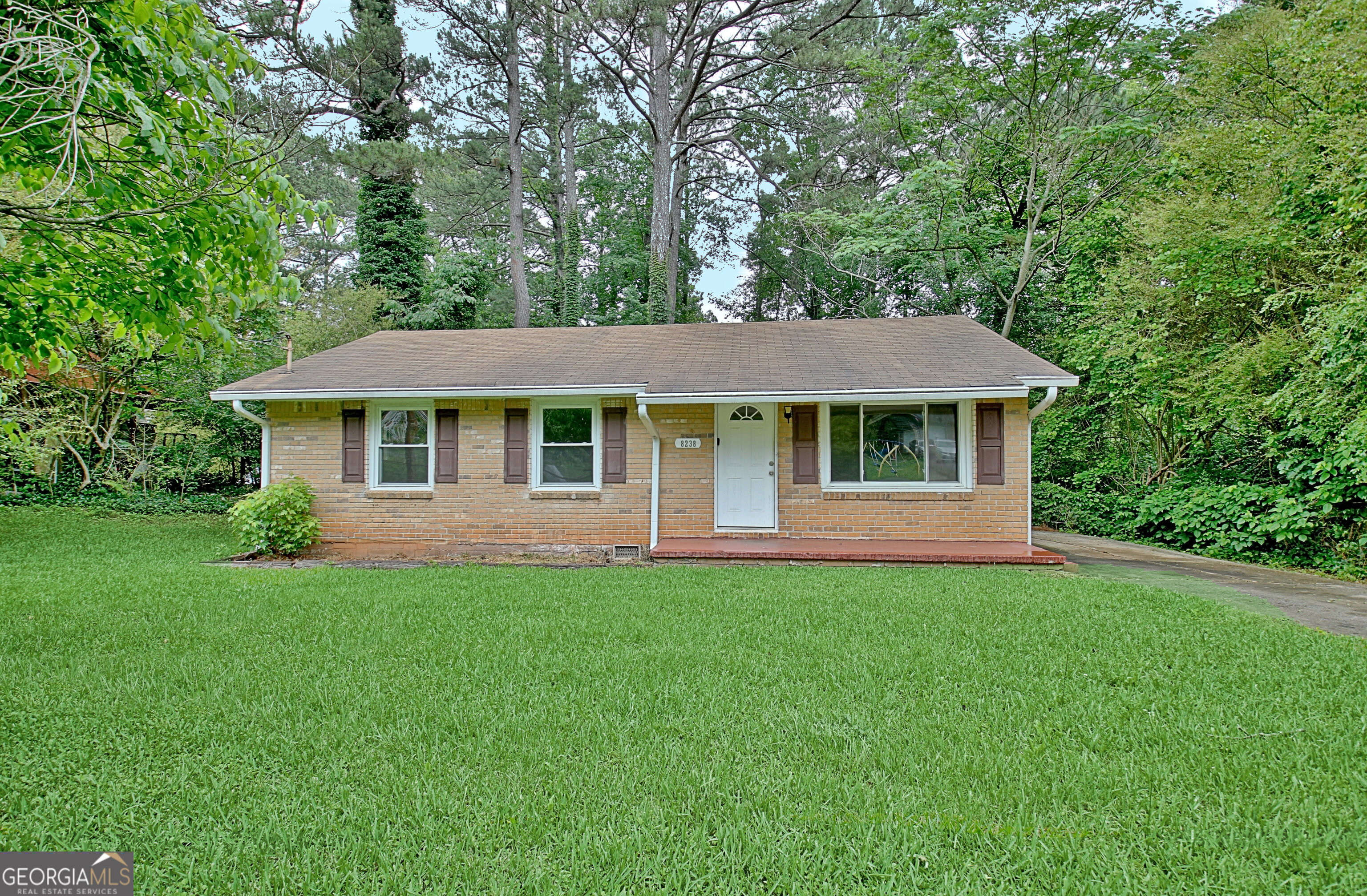 a front view of a house with a garden