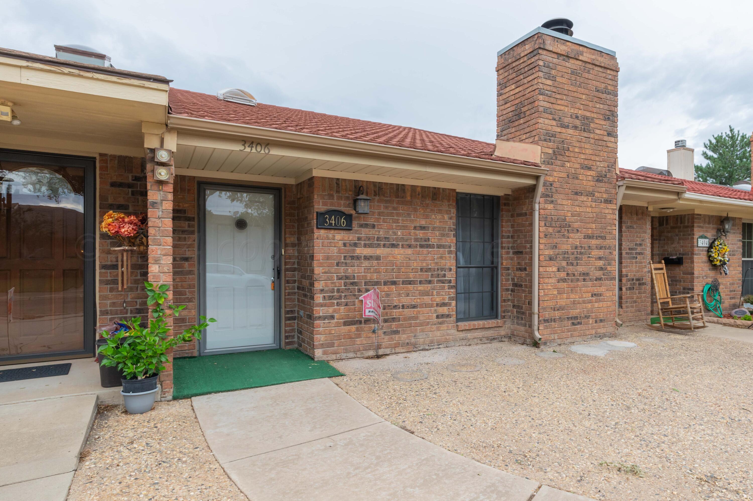 front view of a brick house with a small yard