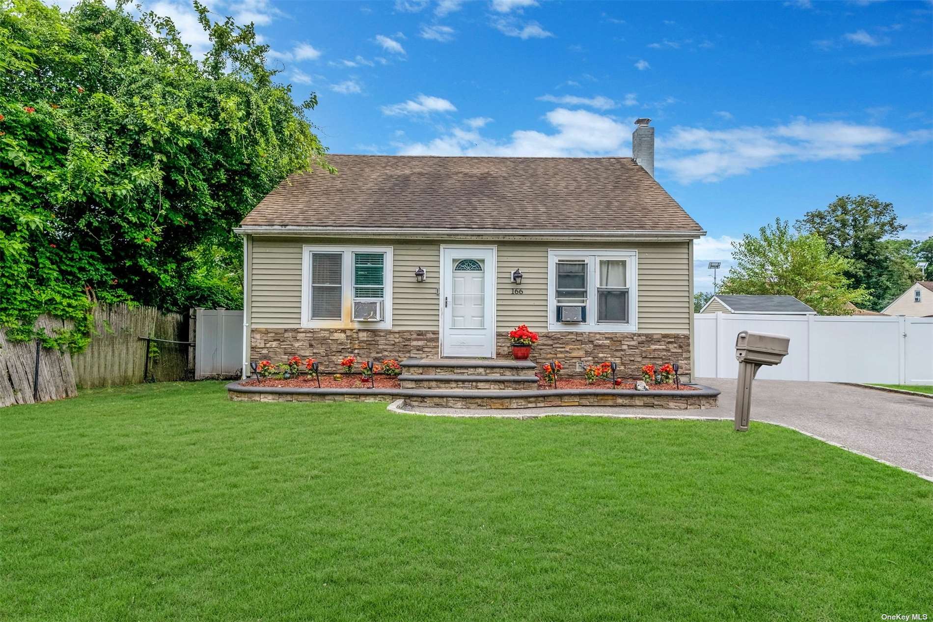 a view of a house with a yard and sitting area