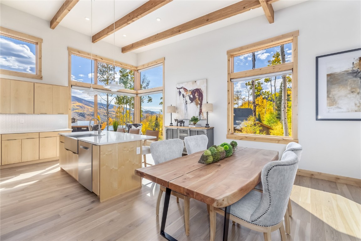 a view of a dining room with furniture kitchen and wooden floor