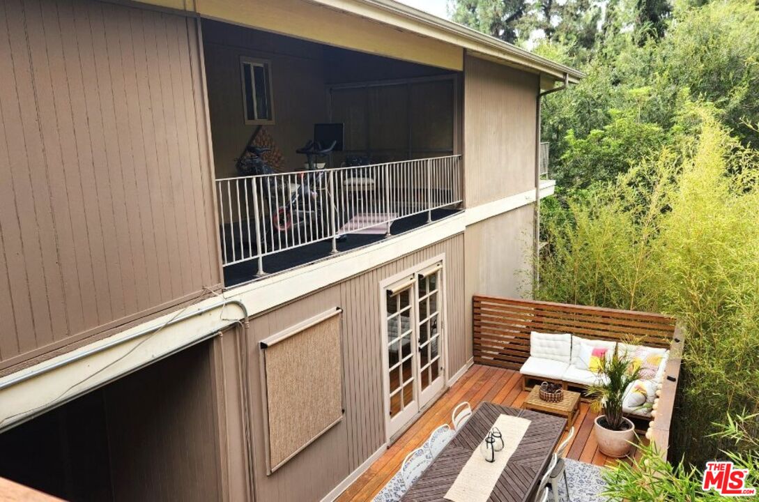 a balcony with wooden floor and outdoor space