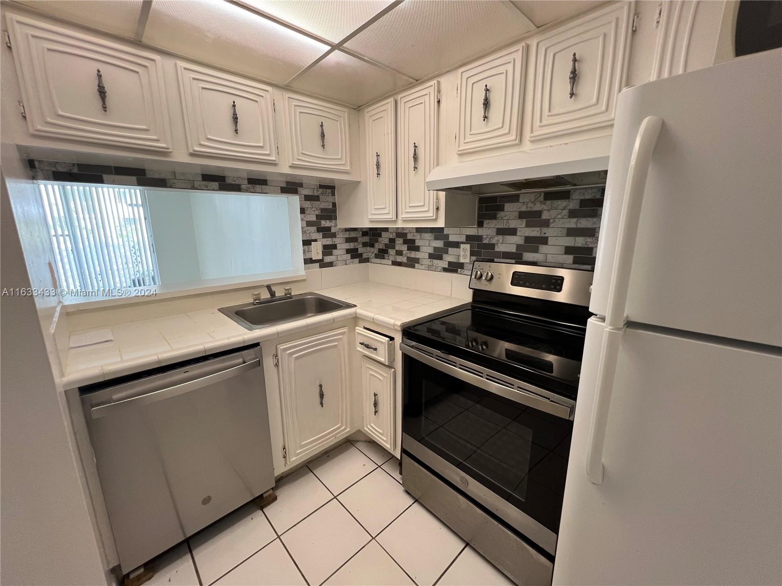 a kitchen with granite countertop cabinets and steel stainless steel appliances