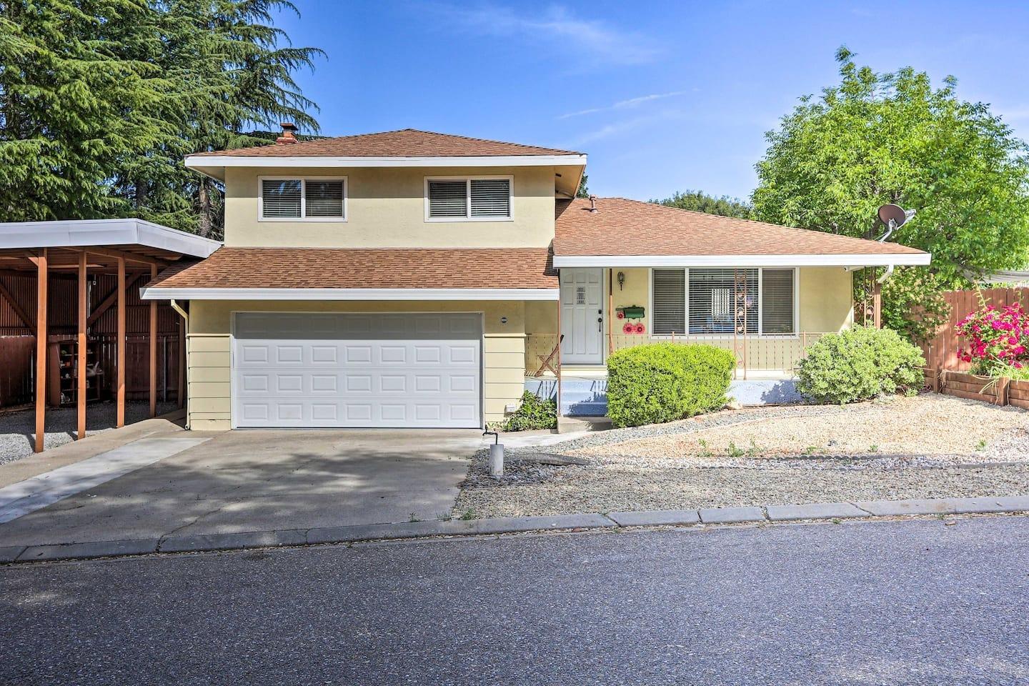 a front view of a house with yard and parking