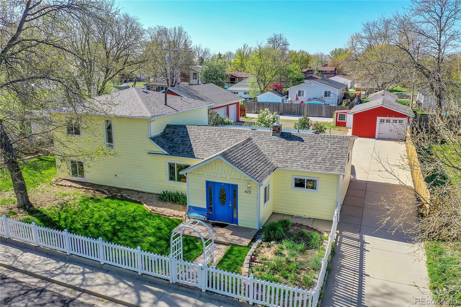 a aerial view of a house with a yard and potted plants