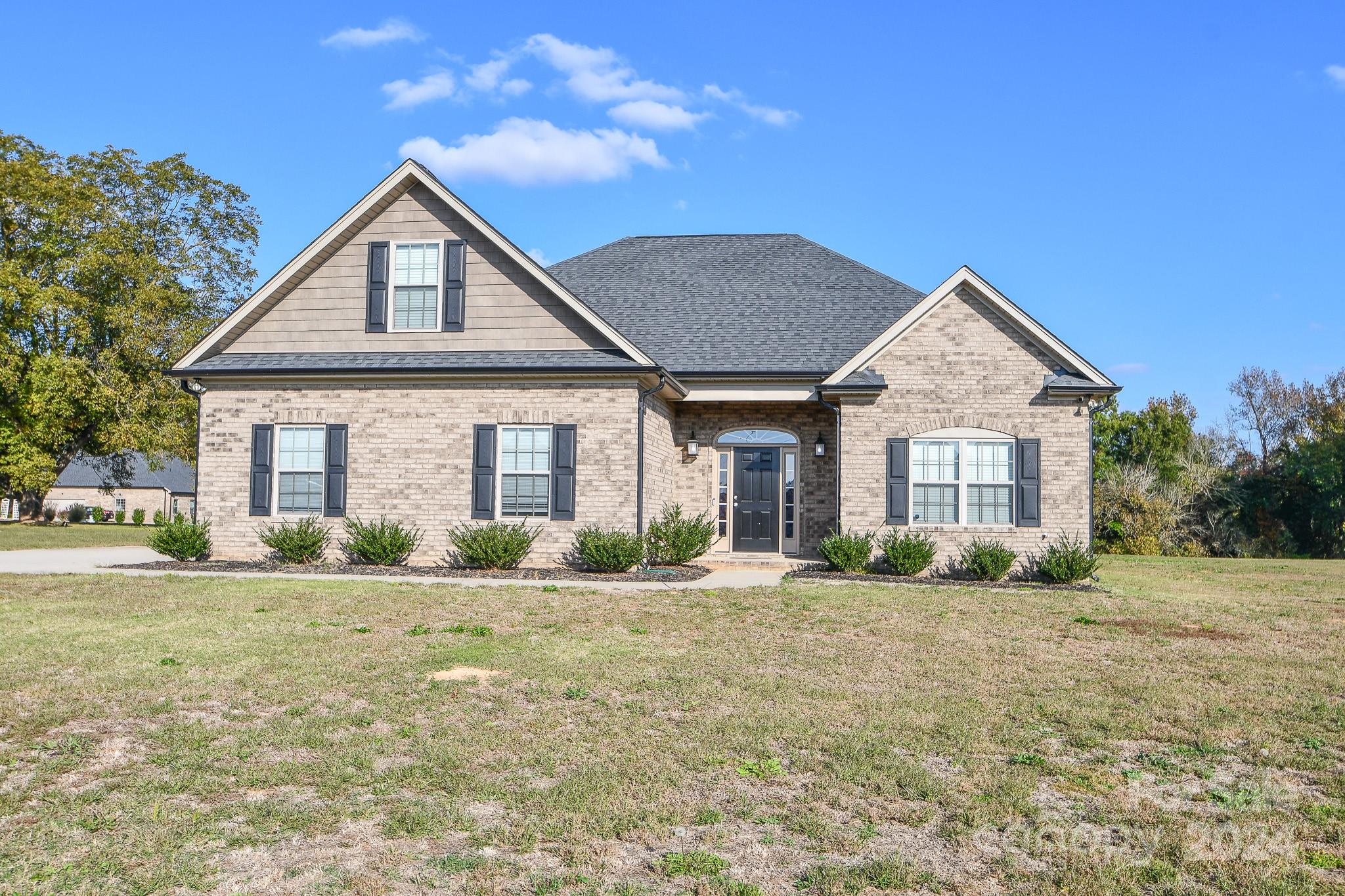 a front view of a house with a yard