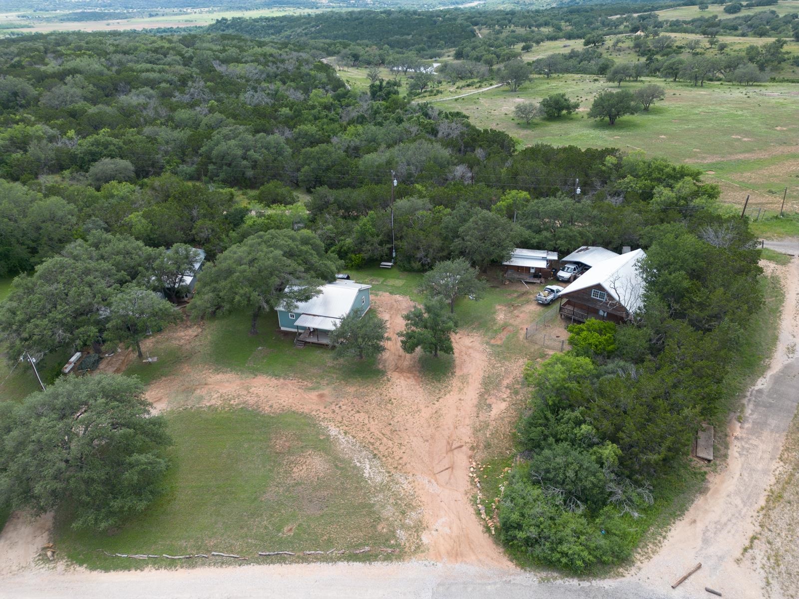 an aerial view of a house with a yard