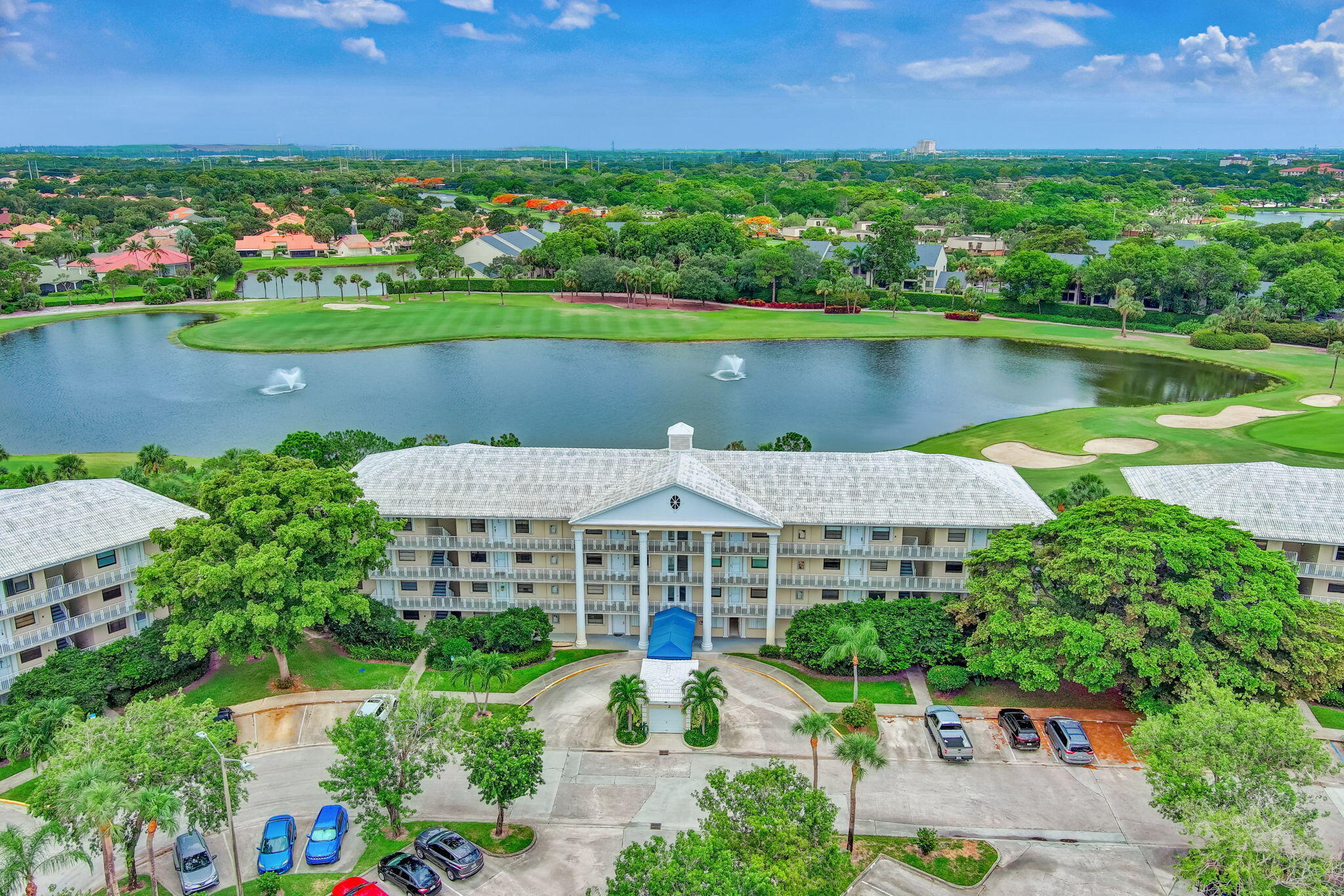 an aerial view of a house with a garden and lake view