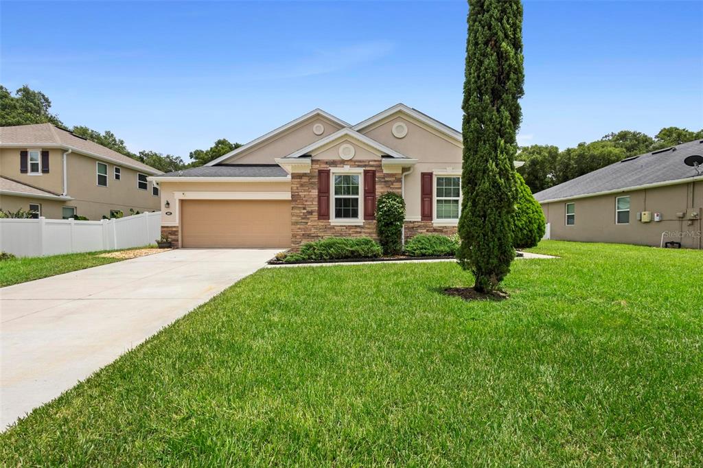 a front view of a house with garden