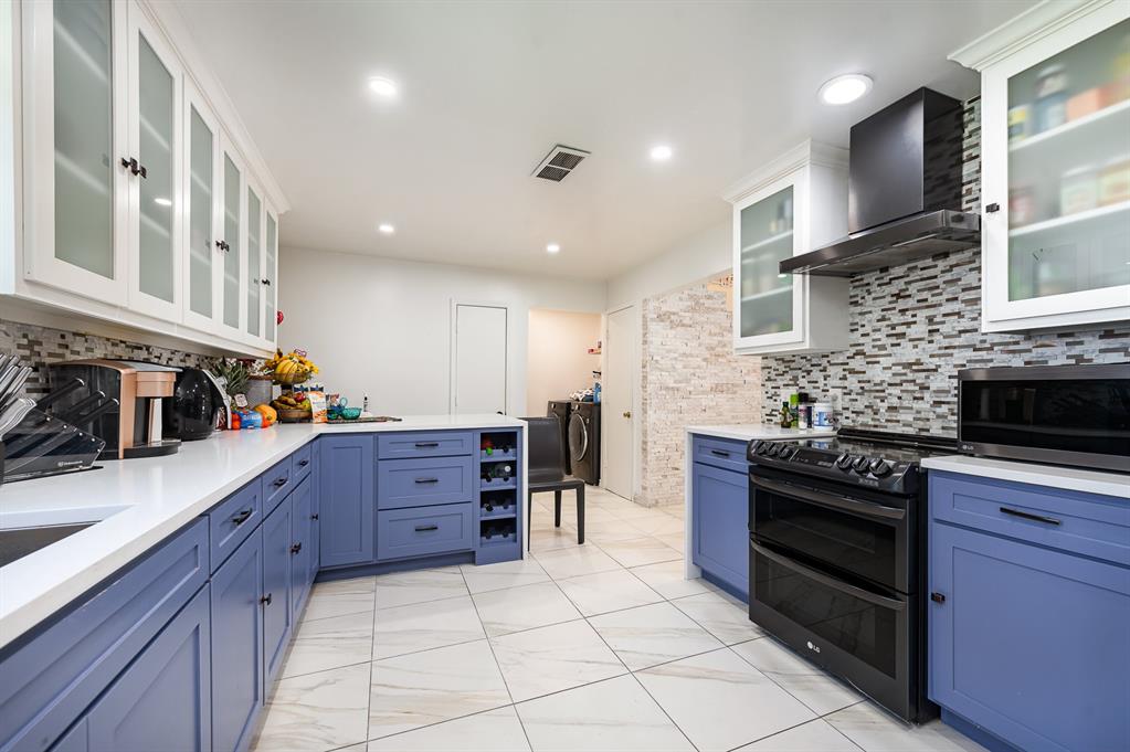 a kitchen with stainless steel appliances and cabinets