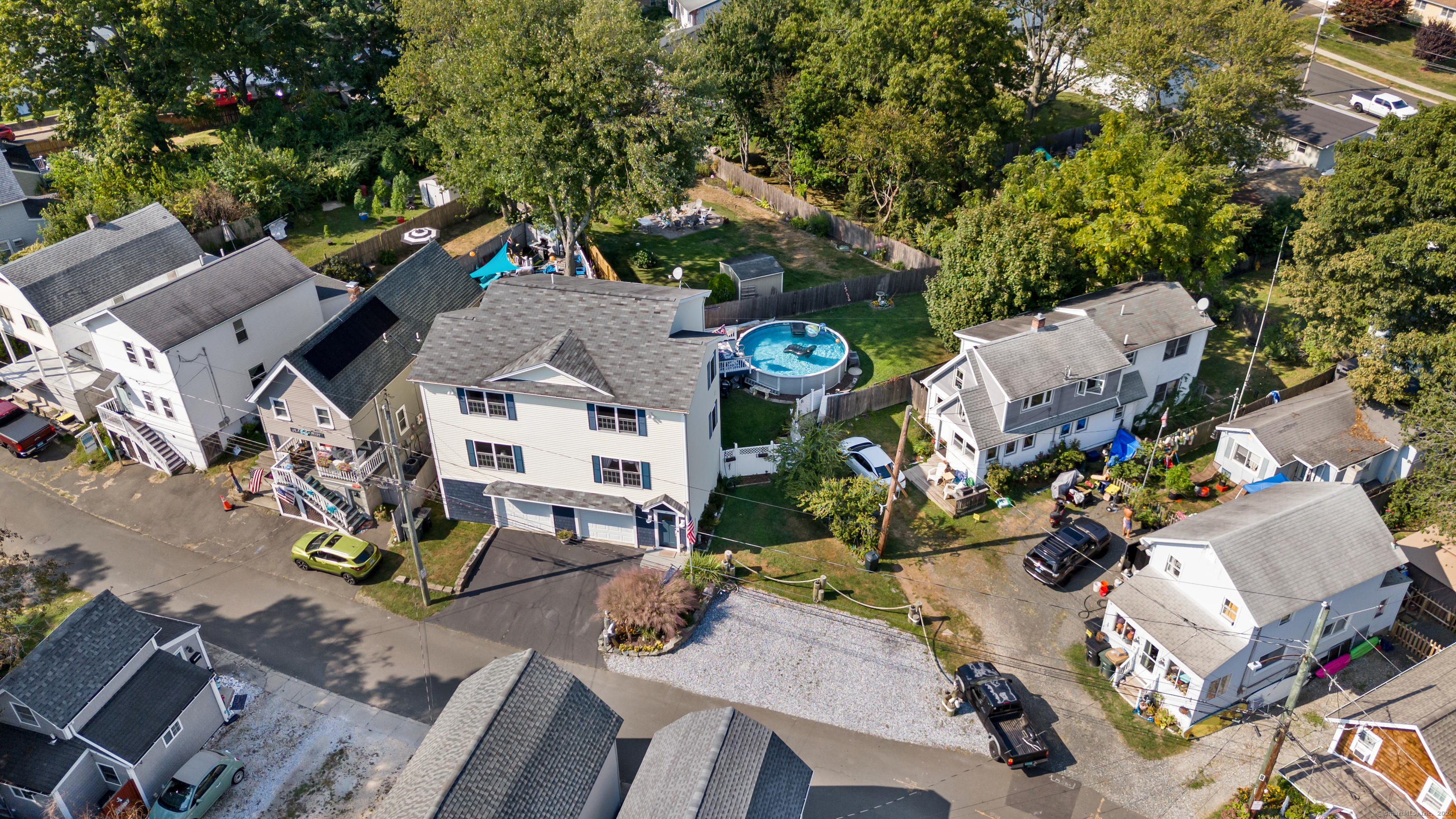 an aerial view of a house with a swimming pool patio and outdoor seating