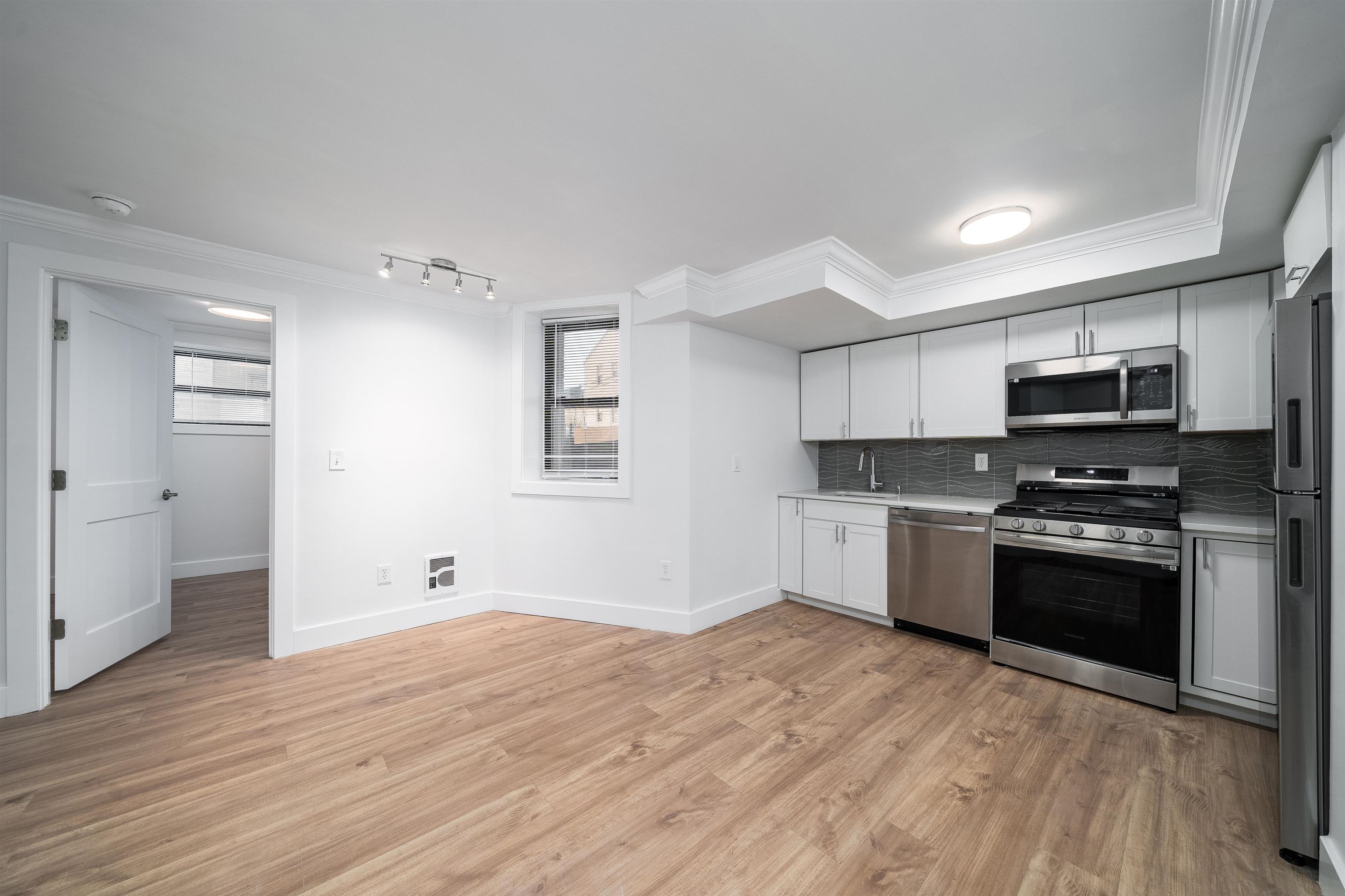 a kitchen with stainless steel appliances granite countertop a refrigerator and a stove top oven