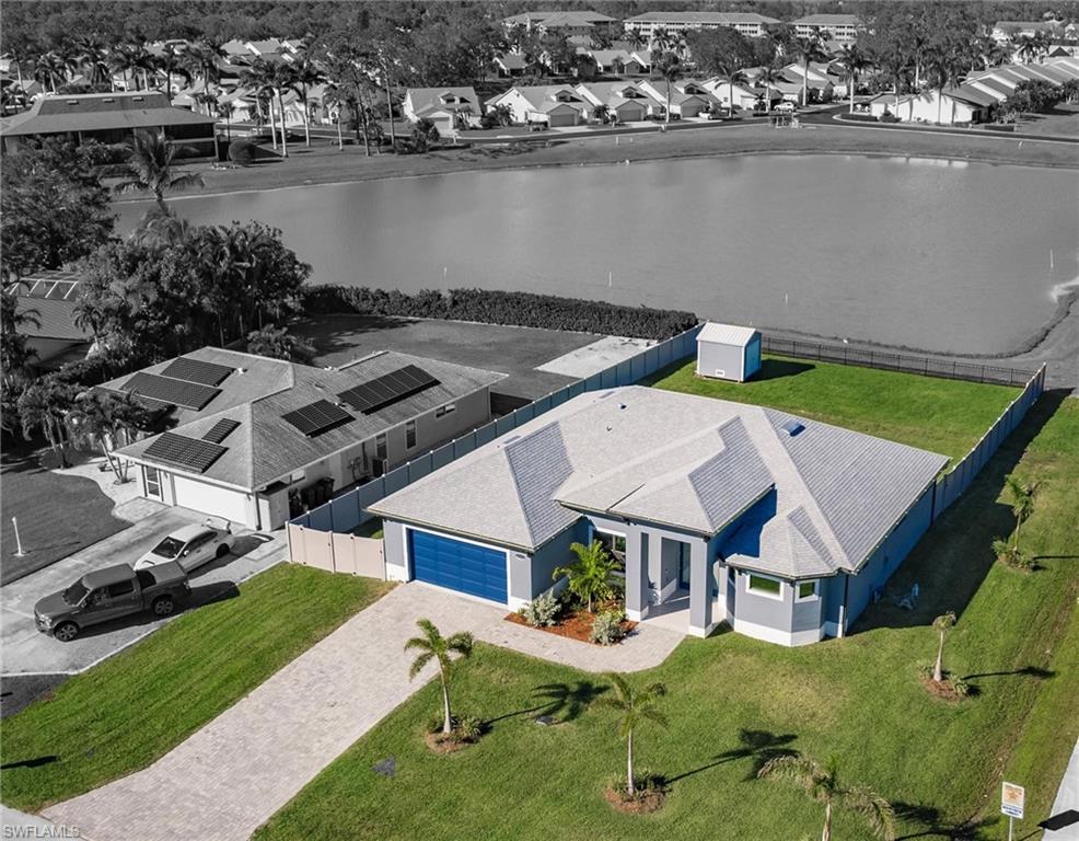 an aerial view of a house with a garden and lake view